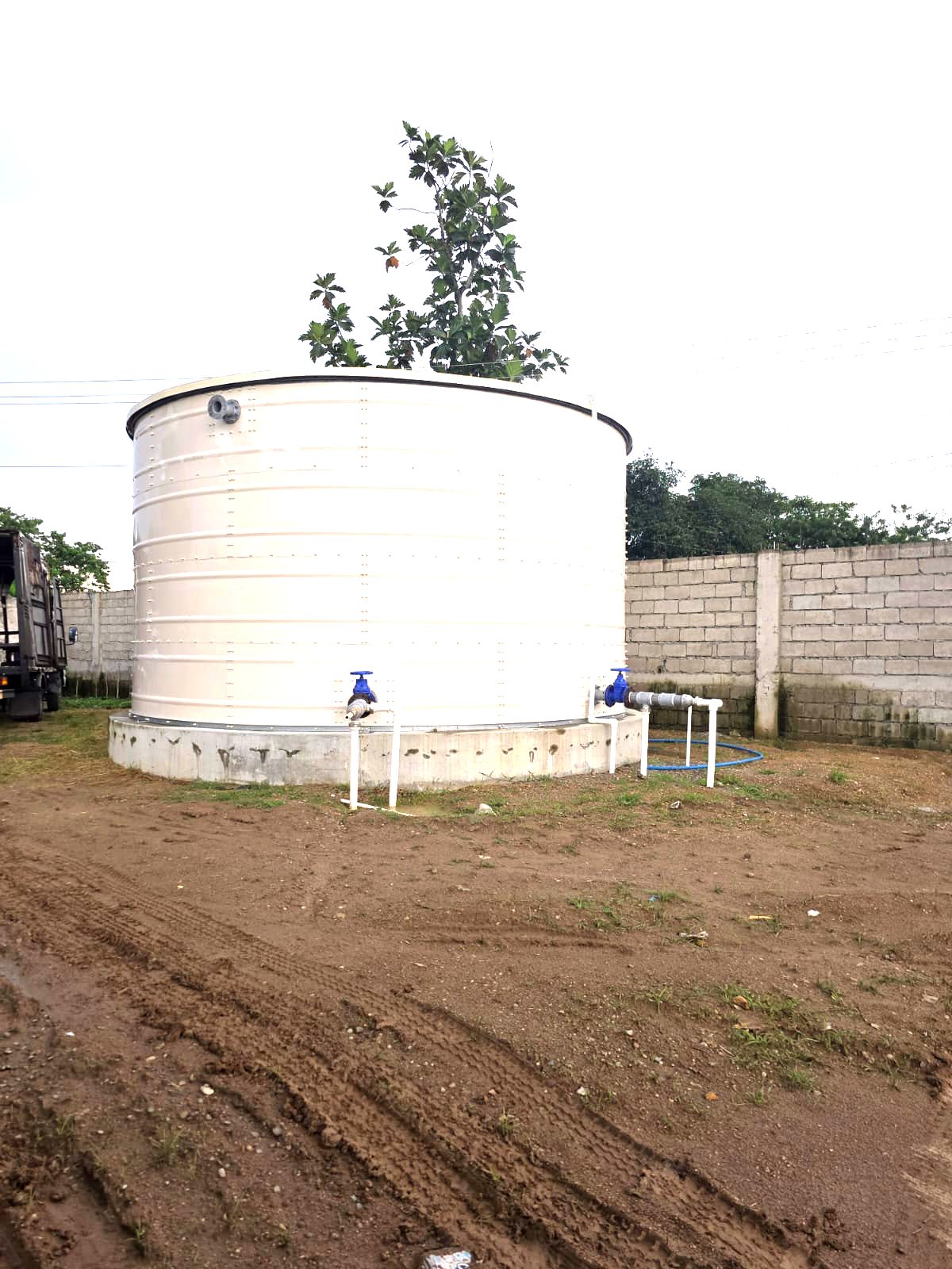 Steel water tank with outlet valves on a finished base
